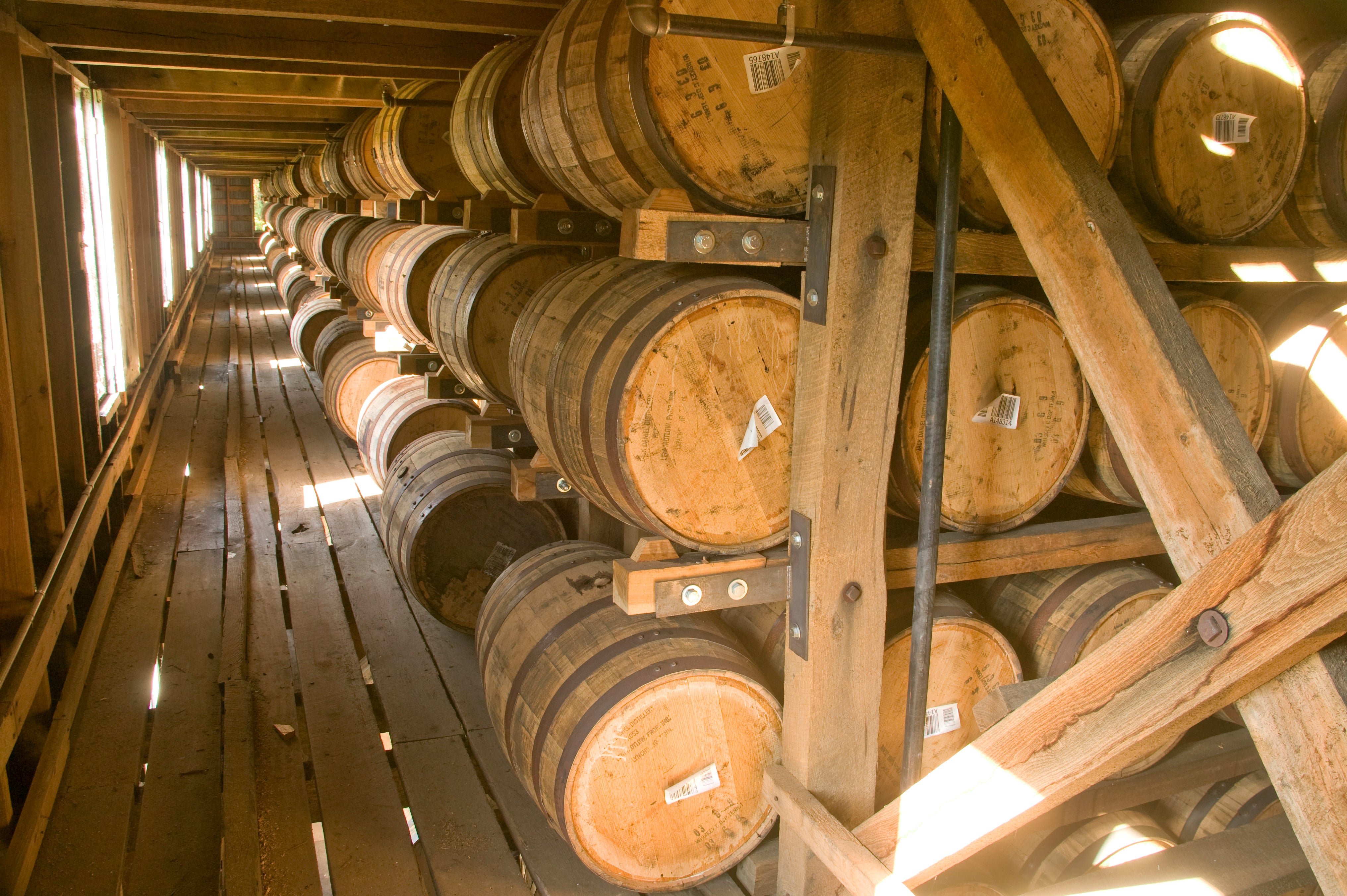 Racked oak barrels aging in a Jack Daniel Distillery barrelhouse